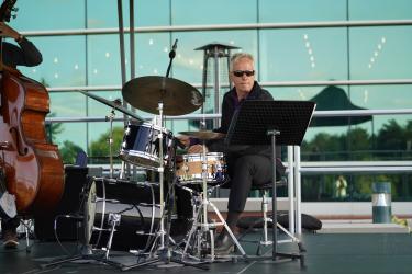 Drummer with sunglasses with a bass on the side